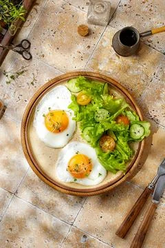 Breakfast concept with coffee and eggs, micro greens and salad. Beige backg.. Stock Photos