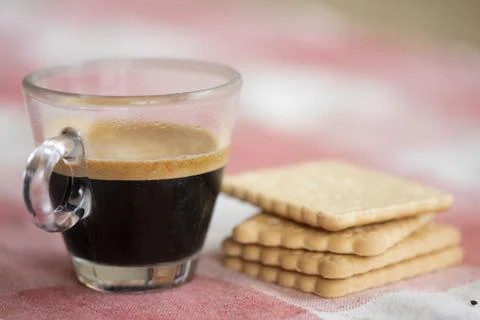 Breakfast concept with an espresso coffee next to cookies on pink background Stock Photos