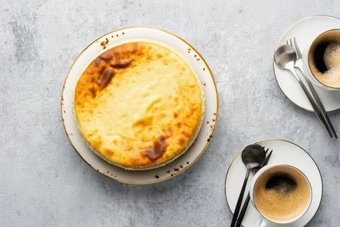 Breakfast concept. Top view of acottage cheese casserole with cups of coffee on Stock Photos
