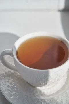 Breakfast concept. white cup of tea couple coffee on white background, sunlight Stock Photos