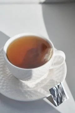 Breakfast concept. white cup of tea couple coffee on white background, sunlight Stock Photos