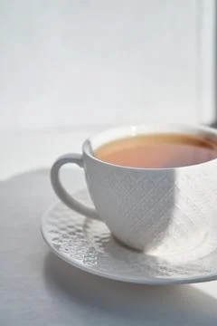 Breakfast concept. white cup of tea couple coffee on white background, sunlig Stock Photos