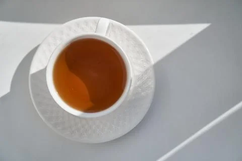 Breakfast concept. white embossed cup of tea coffee on white background Stock Photos