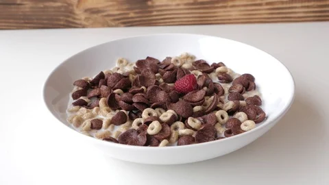 Breakfast: corn flakes with milk and raspberries. Stock Footage 77567674