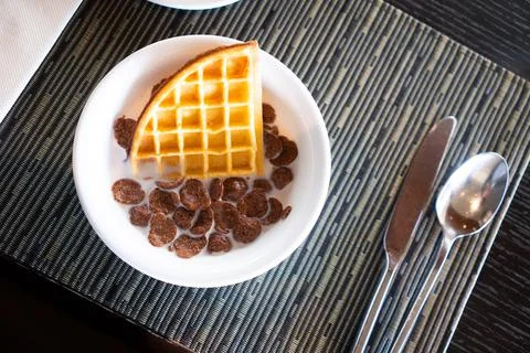 Breakfast cornflakes and bread in milk Stock Photos