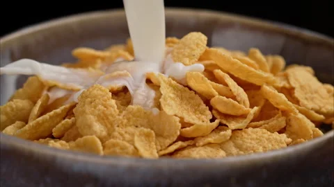 Breakfast with cornflakes in the morning sunlight. 스톡 동영상 302390968