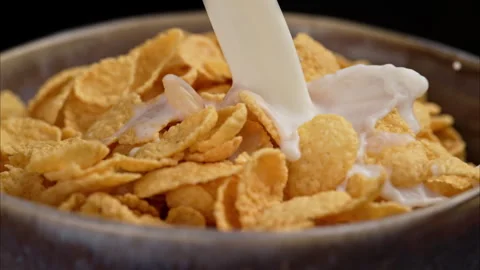 Breakfast with cornflakes in the morning sunlight. 動画素材 302391643