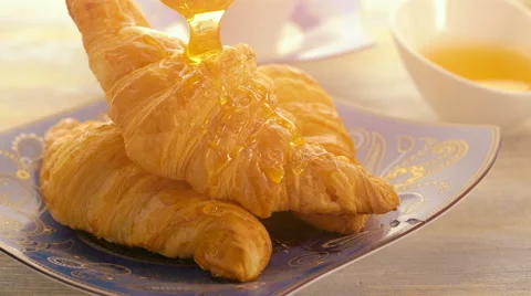 Breakfast with croissant, cup of coffee and honey Stock Footage 62724723