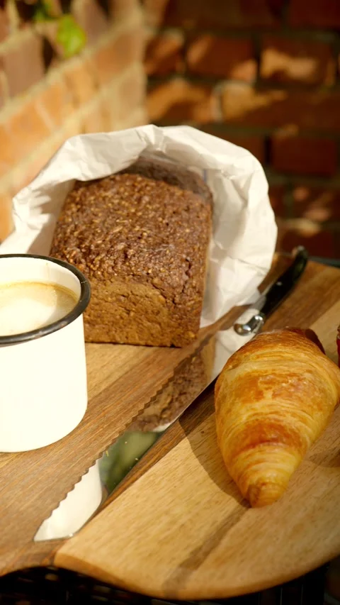 Breakfast with croissant with marmelade, dark bread with bread knife 動画素材 285319646