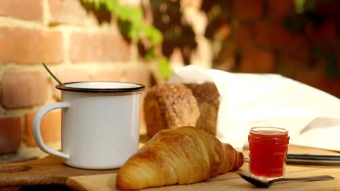 Breakfast with croissant with marmelade, dark bread with bread kn Видео 285319653