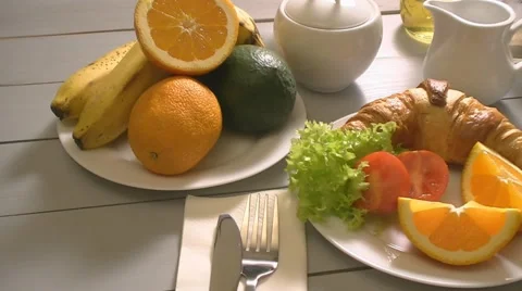 Breakfast with croissant, tomato end tea Stock Footage 47400013