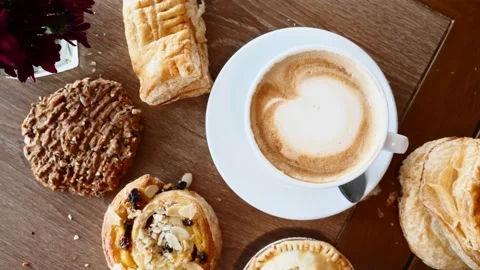 Breakfast with Croissants, Pie, Cookie and Cup of Coffee on Wooden Table in Cafe 库存影片 136718401