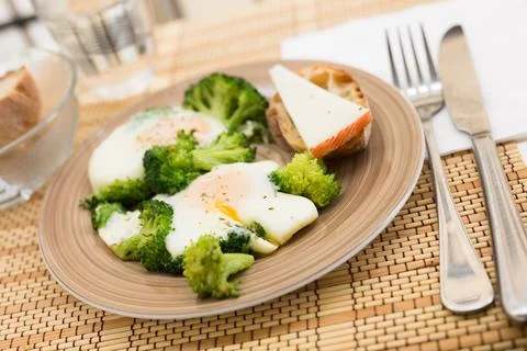 Breakfast of crumpled eggs with broccoli Stock Photos