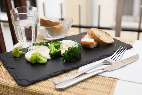 Breakfast of crumpled eggs with broccoli Stock Photos