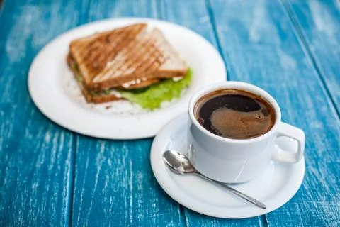 Breakfast with a cup of coffee and two toasted sandwiches. Stock Photos