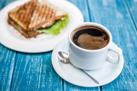 Breakfast with a cup of coffee and two toasted sandwiches. Stock Photos