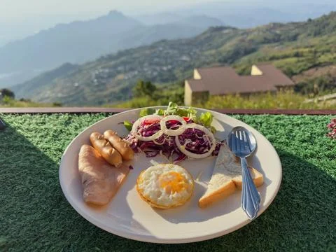 Breakfast dish with mountain view background Stock Photos
