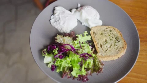 Breakfast dish with vegetables salad, eggs, bread. Healthy breakfast, lunch food Stock Footage 252368460