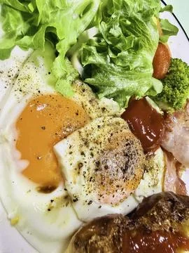 Breakfast dish.there are fried eggs,bread,some vegetable,bacon Stock Photos