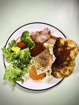 Breakfast dish.there are fried eggs,bread,some vegetable,bacon Fotos de archivo