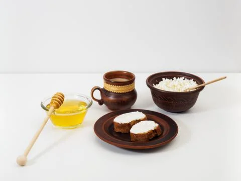 Breakfast in earthenware on a white table Stock Photos