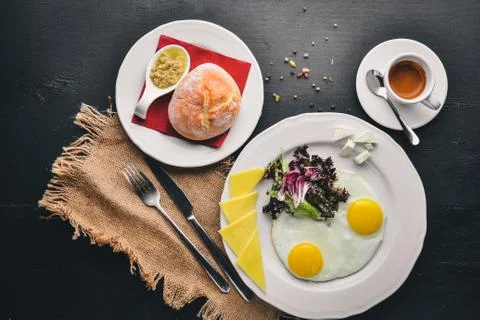 Breakfast. Egg and Burger Beef. Potato frying. On a wooden background. Top vi Stock Photos