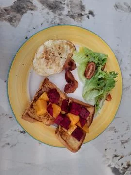 Breakfast, egg with salad and bread with fruits Stock Photos