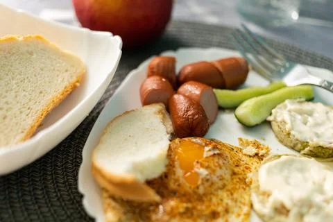 Breakfast of eggs and sausages with bread Stock Photos