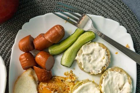 Breakfast of eggs and sausages with bread Stock Photos