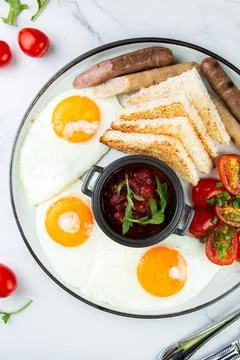 Breakfast of eggs and vegetables with cherry tomatoes and slices of bread top Stock Photos