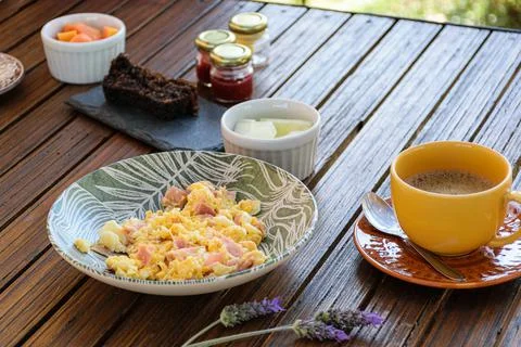Breakfast. Eggs with ham, cup of coffee, melon portion and cookie cake (side  Stock Photos