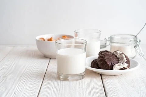Breakfast with fresh milk on a light background. Side view with copy space. Stock Photos