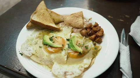 Breakfast fried egg, avocado, toast bread and potato on the table. food footage Stock Footage 168907794