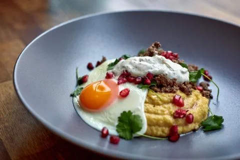 Breakfast - fried egg, beans, tomatoes, mushrooms, garnet.  Stock Photos
