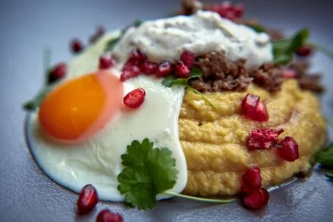 Breakfast - fried egg, beans, tomatoes, mushrooms, garnet.  Stock Photos