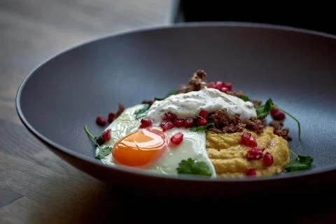 Breakfast - fried egg, beans, tomatoes, mushrooms, garnet.  Stock Photos