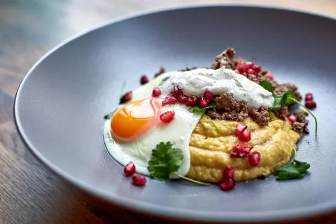 Breakfast - fried egg, beans, tomatoes, mushrooms, garnet.  Stock Photos