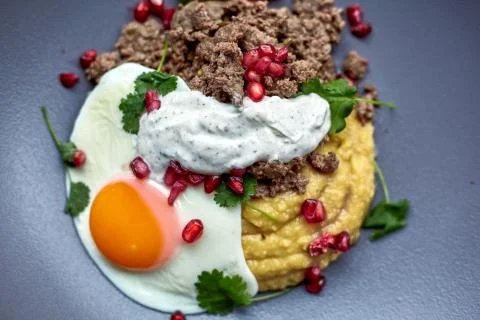 Breakfast - fried egg, beans, tomatoes, mushrooms, garnet.  Stock Photos