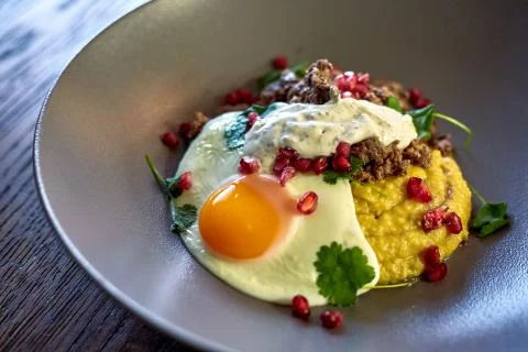 Breakfast - fried egg, beans, tomatoes, mushrooms, garnet.  Stock Photos