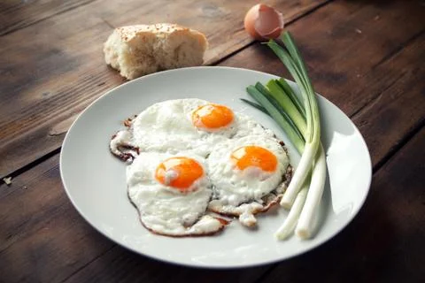 Breakfast with fried eggs and spring onion Stock Photos