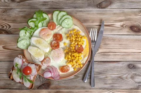 Breakfast. Fried eggs with cherry tomatoes, mozzarella cheese, fresh vegetabl Stock Photos