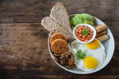 Breakfast with fried eggs. Close up classical traditional English breakfast w Stock Photos