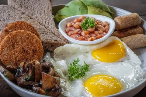 Breakfast with fried eggs. Close up classical traditional English breakfast w Stock Photos