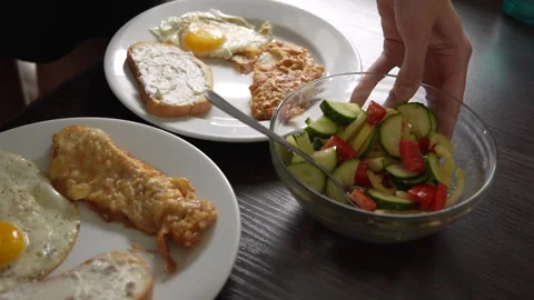 Breakfast fried eggs with salad and toast. Two servings Stock Footage 282923455