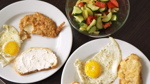 Breakfast fried eggs with salad and toast. Two servings Stock Footage 282923460