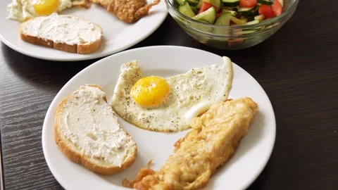 Breakfast fried eggs with salad and toast. Two servings Stock Footage 283449689