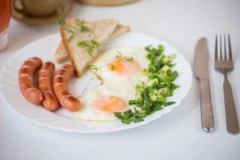 Breakfast - fried eggs on the white plate Stock Photos