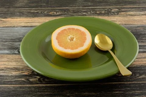Breakfast grapefruit half on plate Stock Photos