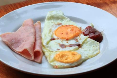 Breakfast, ham and fried eggs with ketchup. Stock Photos