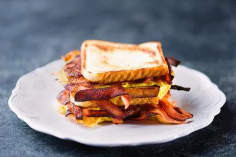 Breakfast ham, bacon and egg sandwich Stock Photos